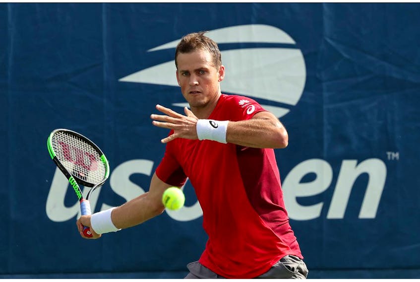 NEW YORK, NEW YORK - AUGUST 27: Vasek Pospisil of Canada returns a shot against Karen Khachanov of Russia during their Men's Singles first round match on day two of the 2019 US Open at the USTA Billie Jean King National Tennis Center on August 27, 2019 in the Flushing neighborhood of the Queens borough of New York City.