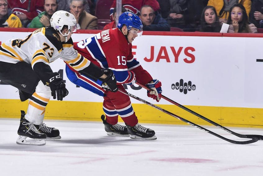  Canadiens’ Jesperi Kotkaniemiskates the puck against Charlie McAvoy of the Boston Bruins at the Bell Centre on Tuesday, Nov. 26, 2019, in Montreal.