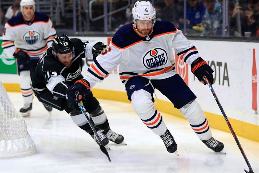 Los Angeles Kings forward Kyle Clifford chases Edmonton Oilers defenceman Adam Larsson during NHL action at Staples Center on Nov. 21, 2019.