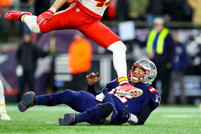 Daniel Sorensen #49 of the Kansas City Chiefs jumps over Tom Brady #12 of the New England Patriots  at Gillette Stadium on Sunday. 
 (Photo by Maddie Meyer/Getty Images)