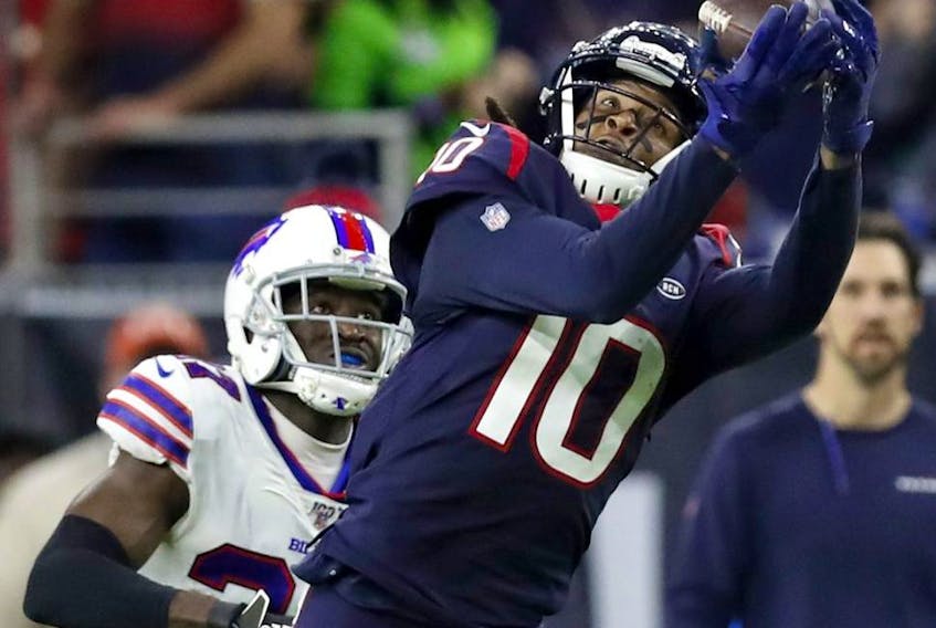 Wide receiver DeAndre Hopkins of the Houston Texans makes a catch over the defense of the Buffalo Bills during the AFC Wild Card Playoff game at NRG Stadium on January 04, 2020 in Houston, Texas.