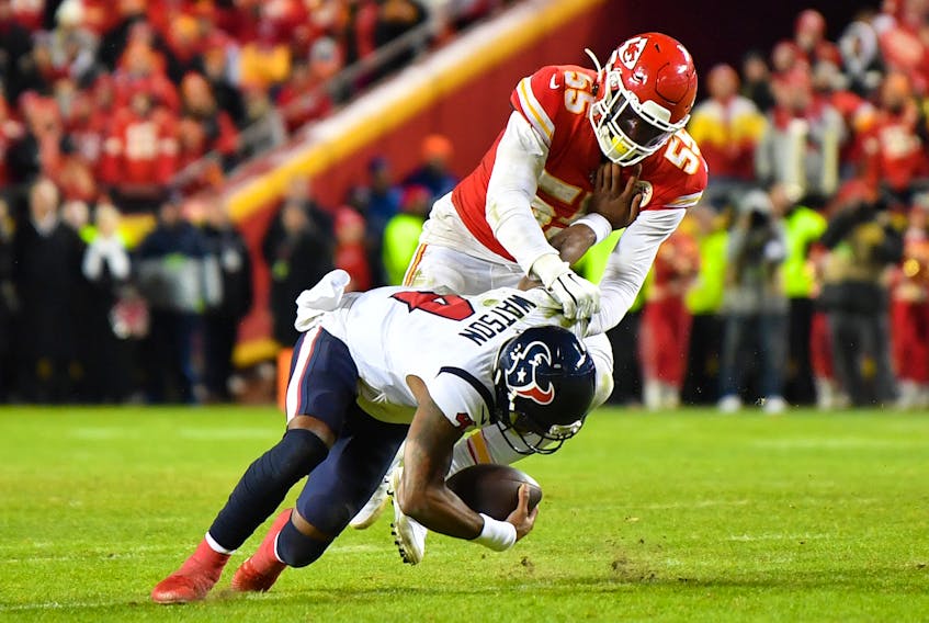 Quarterback Deshaun Watson #4 of the Houston Texans is tackled by Frank Clark #55 of the Kansas City Chiefs during the AFC Divisional playoff game. (Photo by Peter Aiken/Getty Images)
