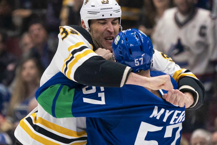 VANCOUVER, BC - FEBRUARY 22: Zdeno Chara #33 of the Boston Bruins and Tyler Myers #57 of the Vancouver Canucks get tangled up at centre ice during NHL action at Rogers Arena on February 22, 2020 in Vancouver, Canada.