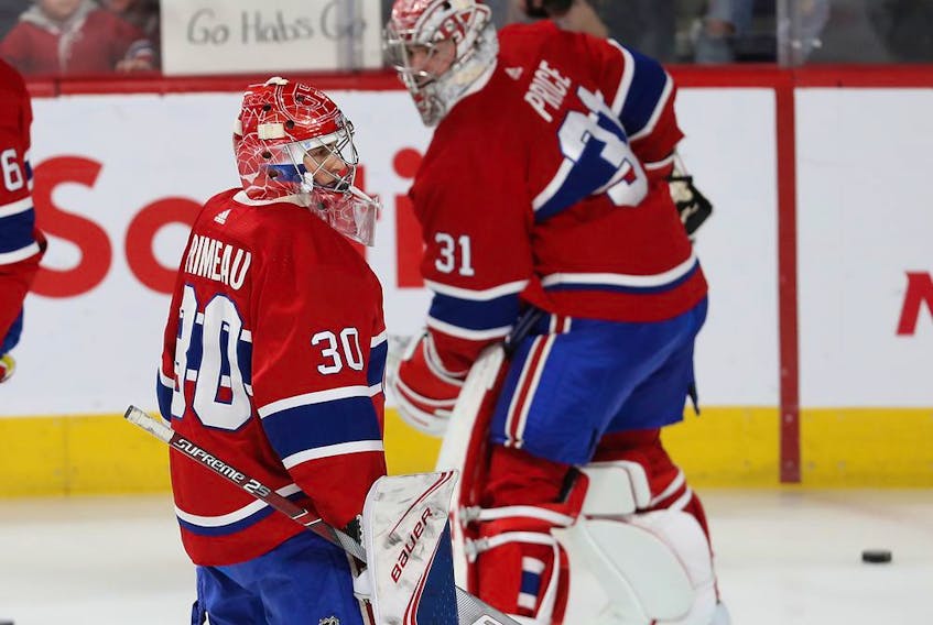  Montreal Canadiens goaltender Cayden Primeau passes Carey Price during warmup session before game against the Colorado Avalanche in Montreal on Dec. 5, 2019.