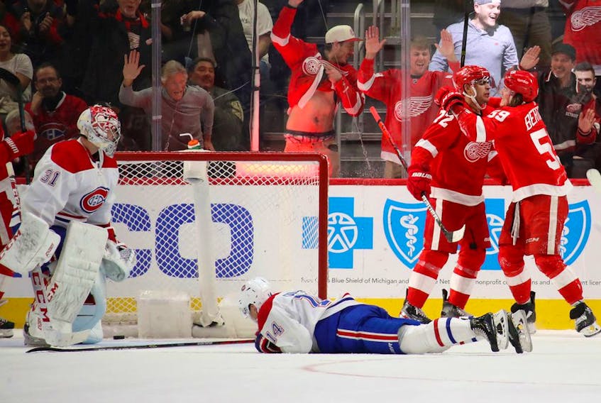  Wings’ Andreas Athanasiou celebrates his winning goal with Tyler Bertuzzi, as Canadiens goalie Carey Price and rookie Nick Suzuki look on in disgust Tuesday night in Detroit.