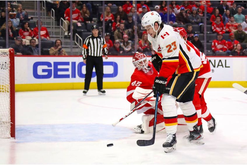 Sean Monahan of the Calgary Flames scores a first-period goal past Jonathan Bernier of the Detroit Red Wings at Little Caesars Arena on February 23, 2020 in Detroit, Michigan.