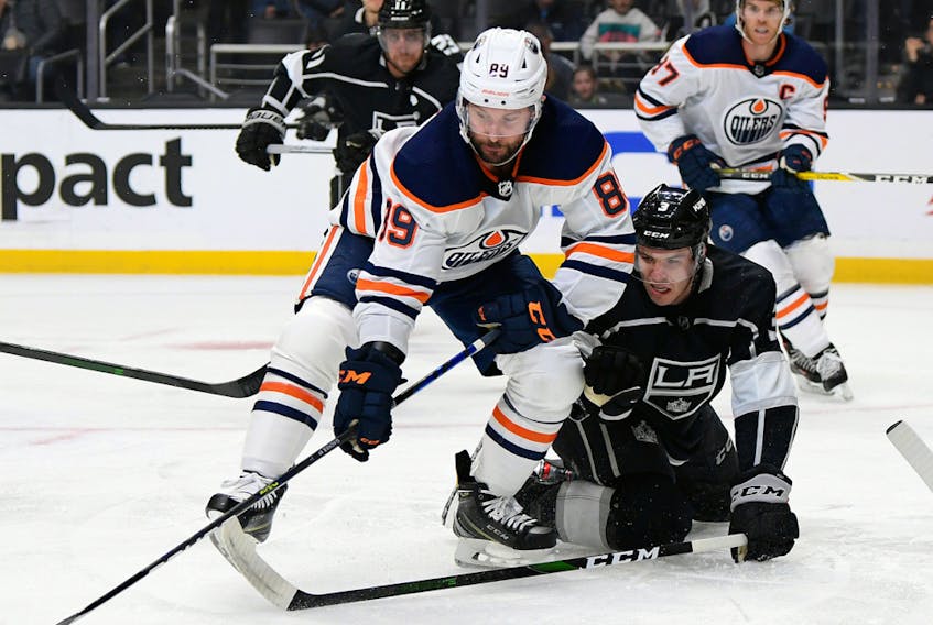 Sam Gagner (89) of the Edmonton Oilers reaches for the puck in front of Matt Roy (3) of the Los Angeles Kings at Staples Center on Feb. 23, 2020, in Los Angeles, Calif.