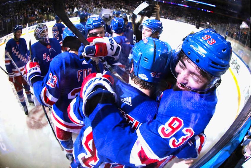 Brendan Lemieux and Mika Zibanejad (93) of the New York Rangers celebrate an overtime victory over the Washington Capitals at Madison Square Garden on March 05, 2020 in New York City. Zibanejad had five goals in the game.