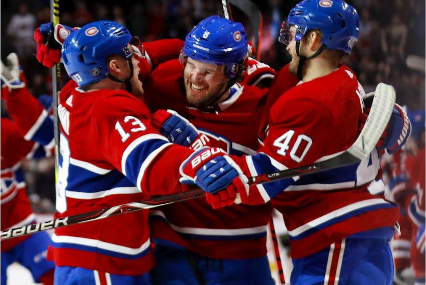 Canadiens defenseman Ben Chiarot (centre) celebrates with teammates Max Domi (left) and Joel Armia after scoring in overtime to give his team a 3-2 win over the Ottawa Senators in NHL game at the Bell Centre in Montreal on Dec. 11, 2019.