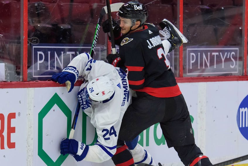 Josh Brown #3 of the Ottawa Senators checks Wayne Simmonds #24 of the Toronto Maple Leafs 