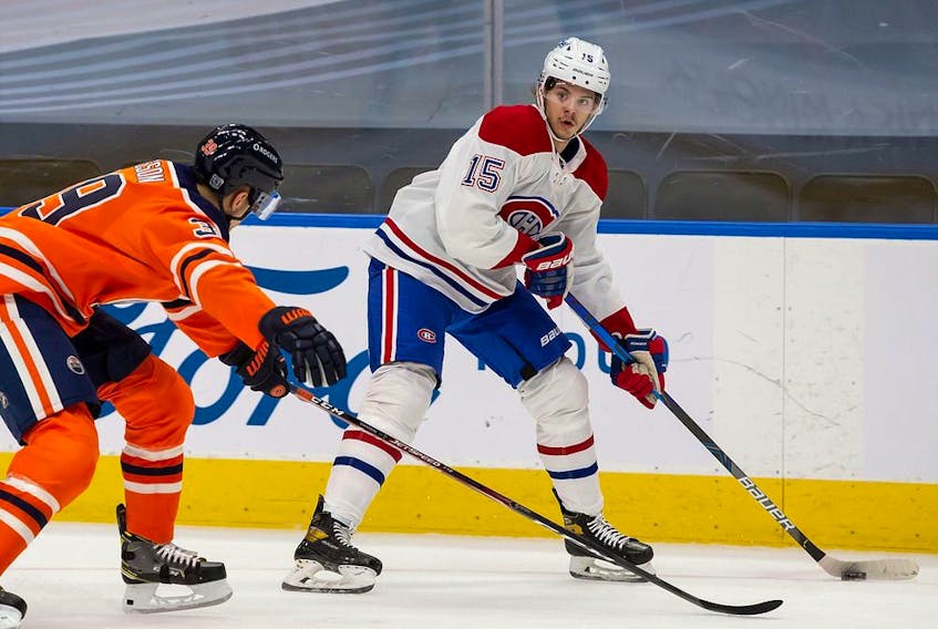 Oiler's Alex Chiasson defends against Canadiens' Jesperi Kotkaniemi Monday night in Edmonton. Kotkaniemi is one of the players Montreal has stashed on the taxi squad this season to save money against the  salary cap. 