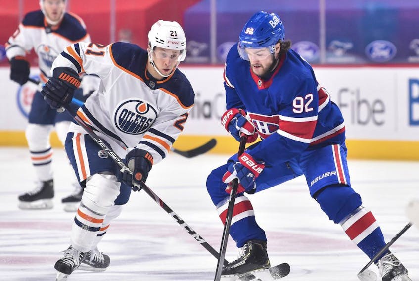 Dominik Kahun (No. 21) of the Edmonton Oilers skates against Jonathan Drouin (No. 92) of the Montreal Canadiens during the first period at the Bell Centre in Montreal on February 11, 2021.