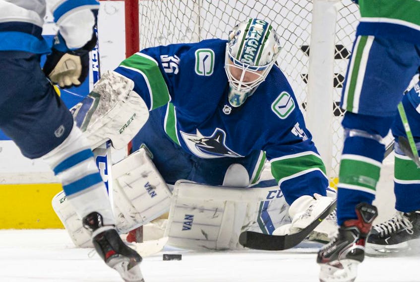 Thatcher Demko of the Canucks makes a save against the Winnipeg Jets during NHL action at Rogers Arena on March 22 in Vancouver.