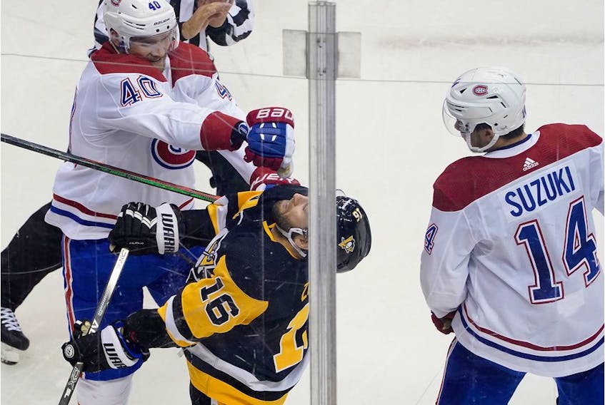 Joel Armia of the Montreal Canadiens, left, and Jason Zucker of the Pittsburgh Penguins mix it up in Game 2 of the Eastern Conference Qualification Round at Scotiabank Arena on Aug. 3, 2020, in Toronto.