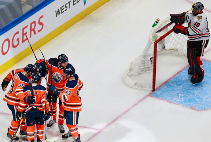 Edmonton Oilers players celebrate forward Alex Chiasson's third-period goal on Chicago Blackhawks goalie Corey Crawford on Aug. 3, 2020, during Game 2 of their Stanley Cup Playoffs qualifying series.