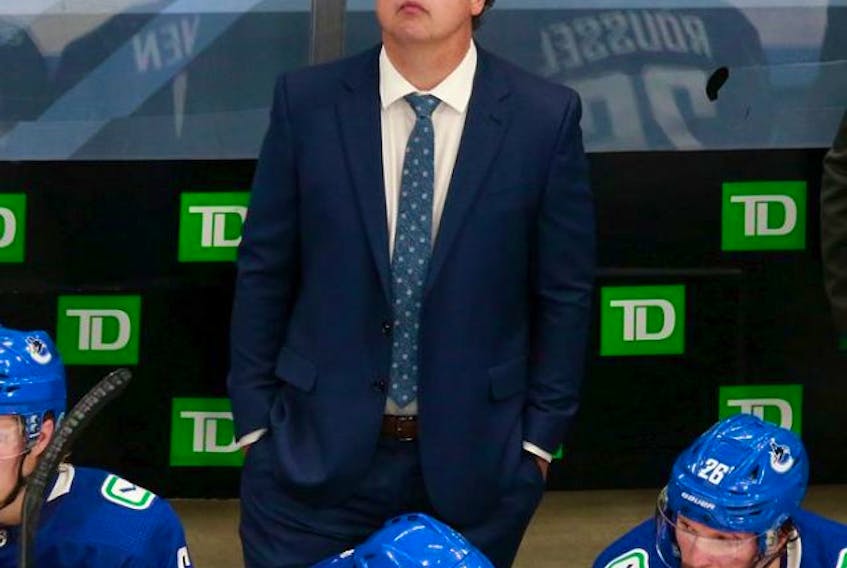Canucks head coach Travis Green looks up at the clock during Tuesday's Game 2 of their qualifying series against the Minnesota Wild at Rogers Place in Edmonton.