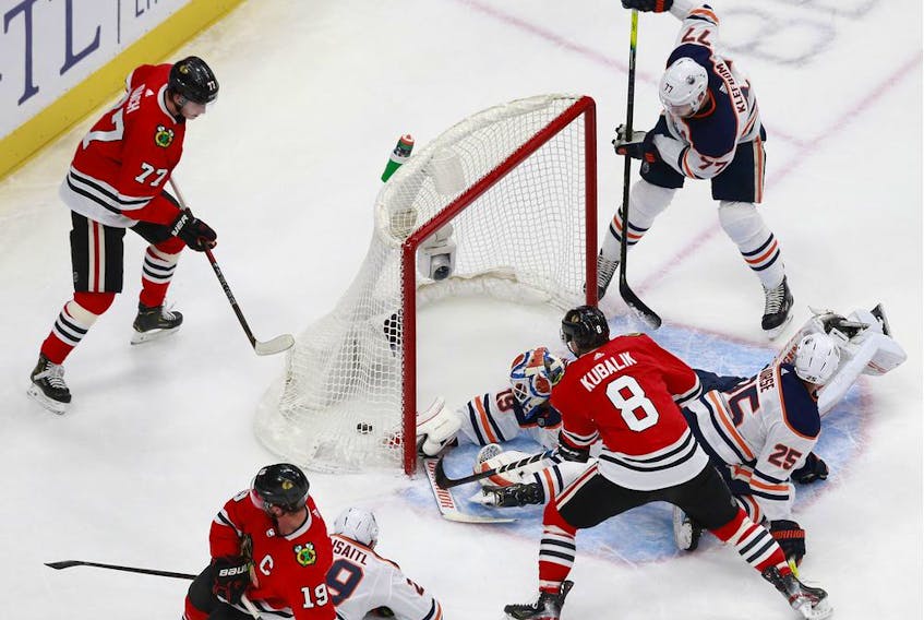 Mikko Koskinen #19 of the Edmonton Oilers allows a goal to Jonathan Toews #19 of the Chicago Blackhawks during the first period in Game 3 of the Western Conference Qualification Round at Rogers Place on August 05, 2020.