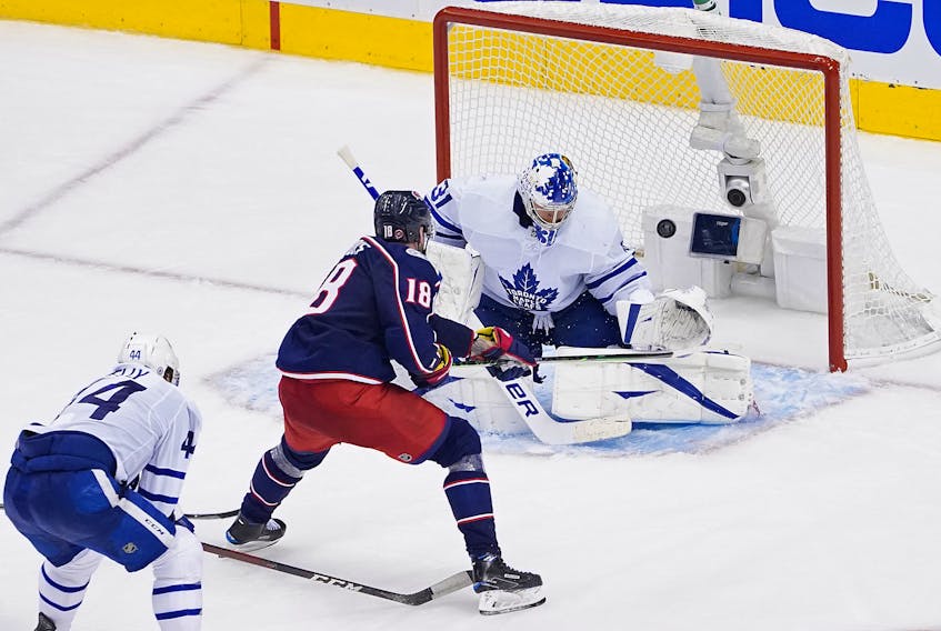 Pierre-Luc Dubois of the Columbus Blue Jackets backhands the game-winning goal past Frederik Andersen of the Toronto Maple Leafs during the first overtime period.