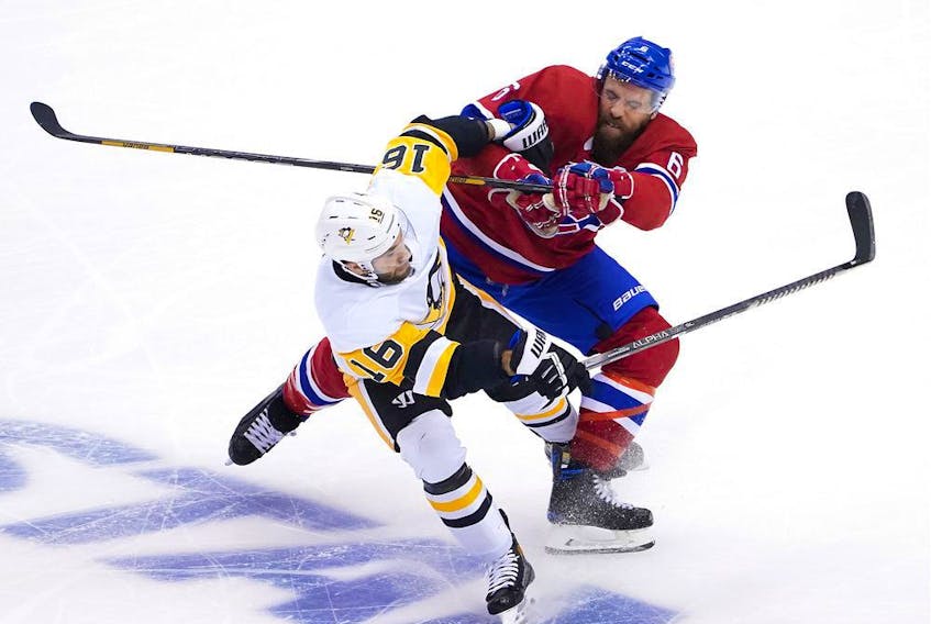 Canadiens defenceman Shea Weber delivers a punishing blow to Penguins forward Jason Zucker on Friday, Aug. 7, 2020, at Scotiabank Arena in Toronto.