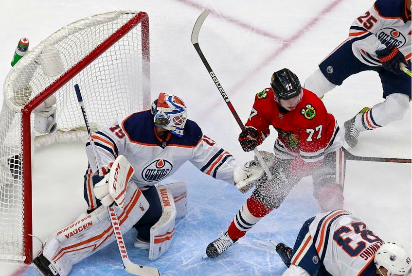 Mikko Koskinen of the Edmonton Oilers tends net against Kirby Dach of the Chicago Blackhawks in Game 4 of the Western Conference Qualification Round prior to the 2020 NHL Stanley Cup Playoffs at Rogers Place in Edmonton on Friday, Aug. 7, 2020.