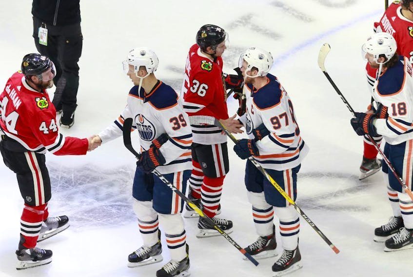 The Chicago Blackhawks and Edmonton Oilers shake hands following the Blackhawks 3-2 victory in Game 4 to win the Western Conference Qualification Round at Rogers Place on August 07, 2020.
