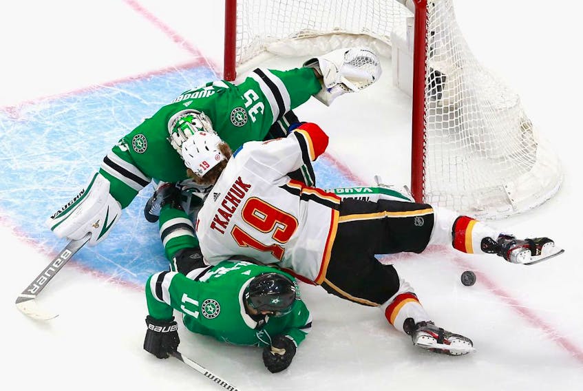 Dallas Stars goaltender Anton Khudobin and teammate Andrew Cogliano defend against Matthew Tkachuk of the Calgary Flames during the second period in Game 1 of the Western Conference first-round series during the 2020 NHL Stanley Cup Playoffs  on Tuesday in Edmonton.