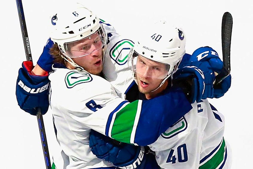 Brock Boeser of the Vancouver Canucks, left, with friend and teammate Elias Pettersson, says he wants to stay in Vancouver and win a Stanley Cup with the Canucks.
