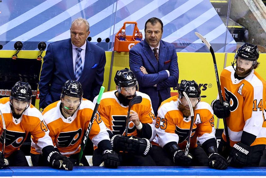 Flyers head coach Alain Vigneault, right, and assistant coach Michel Therrien look on in disgust during Philadelphia's 5-0 loss to the Canadiens Friday afternoon in Toronto.