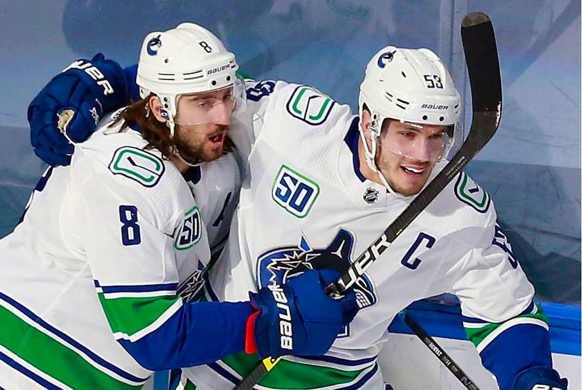 Captain Bo Horvat of the Vancouver Canucks celebrates his shorthanded goal on Friday in Edmonton with Chris Tanev. Horvat also scored in overtime as Vancouver grabbed a 2-0 series lead against the St. Louis Blues.