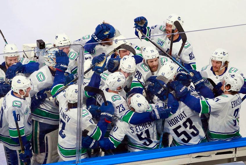 The Vancouver Canucks celebrate their Game 2 overtime victory, courtesy of a Bo Horvat goal, against the St. Louis Blues in their NHL Western Conference first-round playoff series at Rogers Place in Edmonton on Aug. 14, 2020.