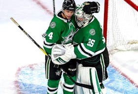 Anton Khudobin #35 and Miro Heiskanen #4 of the Dallas Stars celebrate their teams 2-1 victory against the Vegas Golden Knights in Game Four of the Western Conference Final during the 2020 NHL Stanley Cup Playoffs at Rogers Place on Sept. 12, 2020.