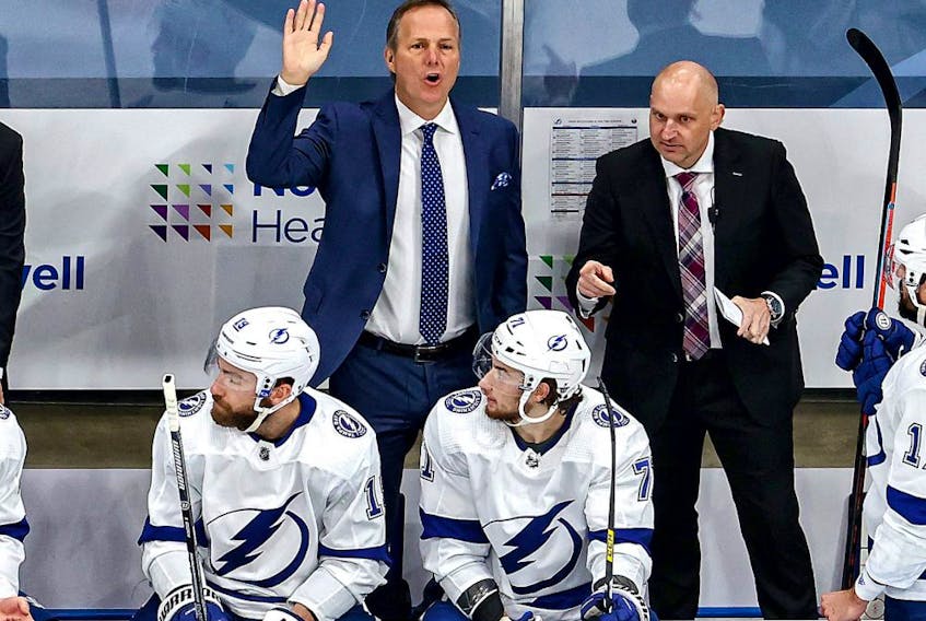 Tampa Bay Lightning head coach Jon Cooper, left, reacts during the first period against the New York Islanders in Game 4 of the Eastern Conference Final during the 2020 NHL Stanley Cup Playoffs at Rogers Place on September 13, 2020.