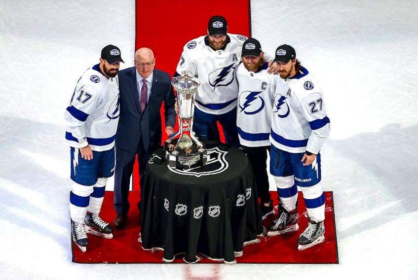 Bill Daly, the deputy commissioner and chief legal officer of the National Hockey League (NHL) presents the Prince of Wales Trophy to captains Alex Killorn #17, Victor Hedman #77, Steven Stamkos #91 and Ryan McDonagh #27 of the Tampa Bay Lightning after winning the Eastern Conference Championship over the New York Islanders in Game Six during the 2020 NHL Stanley Cup Playoffs at Rogers Place on September 17, 2020. 