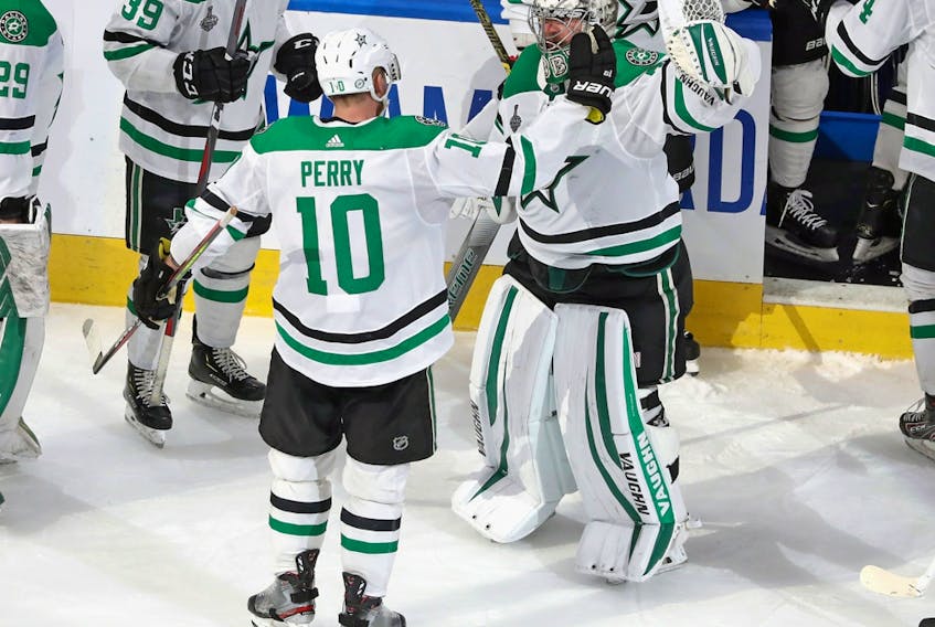Corey Perry (10) and Anton Khudobin (35) of the Dallas Stars celebrate their victory over the Tampa Bay Lightning in the second overtime period of Game 5 of the 2020 NHL Stanley Cup Final at Rogers Place on Sept. 26, 2020.