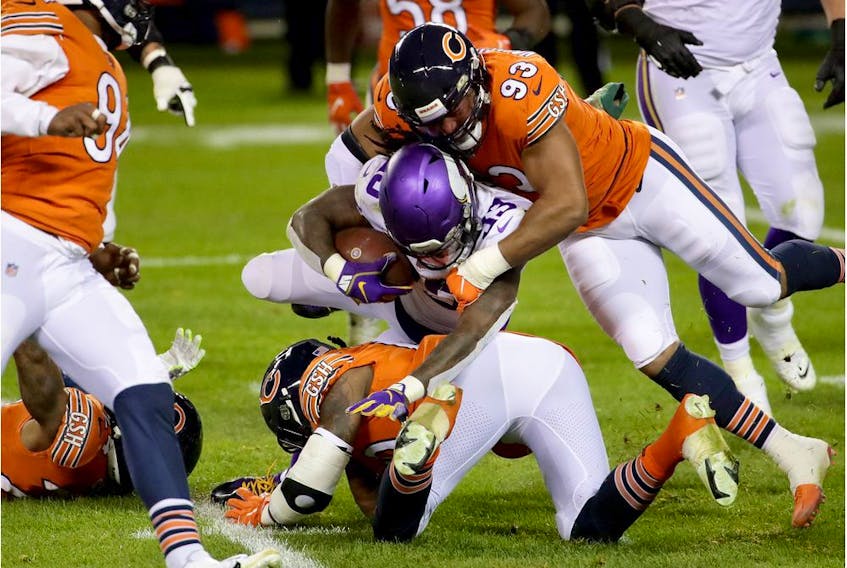 CHICAGO, ILLINOIS - NOVEMBER 16:  Dalvin Cook #33 of the Minnesota Vikings tackled by James Vaughters #93 of the Chicago Bears at Soldier Field on November 16, 2020 in Chicago, Illinois.