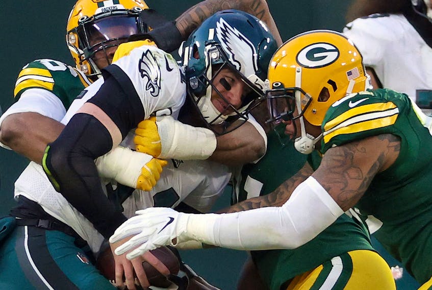 Carson Wentz #11 of the Philadelphia Eagles is sacked by Kingsley Keke #96 and Preston Smith #91 of the Green Bay Packers on Sunday. Wentz was benched in the Packers' win. 
