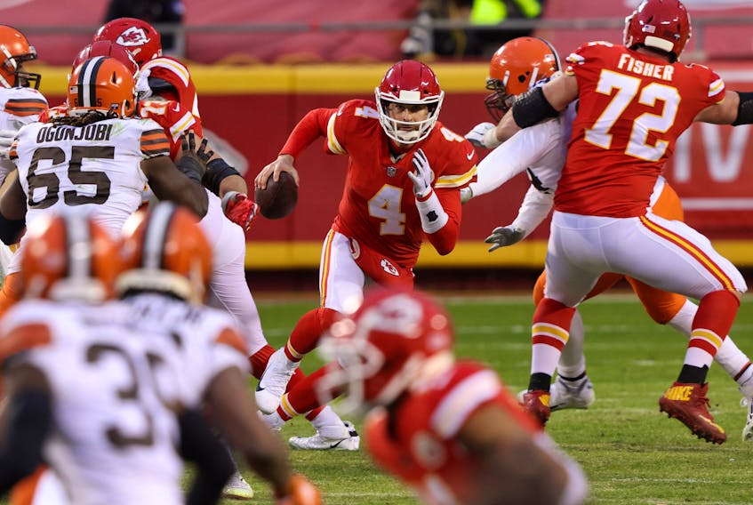 Not known for his running ability, quarterback Chad Henne #4 of the Kansas City Chiefs scrambles against the Cleveland Browns late in the fourth quarter of their AFC Divisional playoff game at Arrowhead Stadium on January 17, 2021 in Kansas City, Missouri.