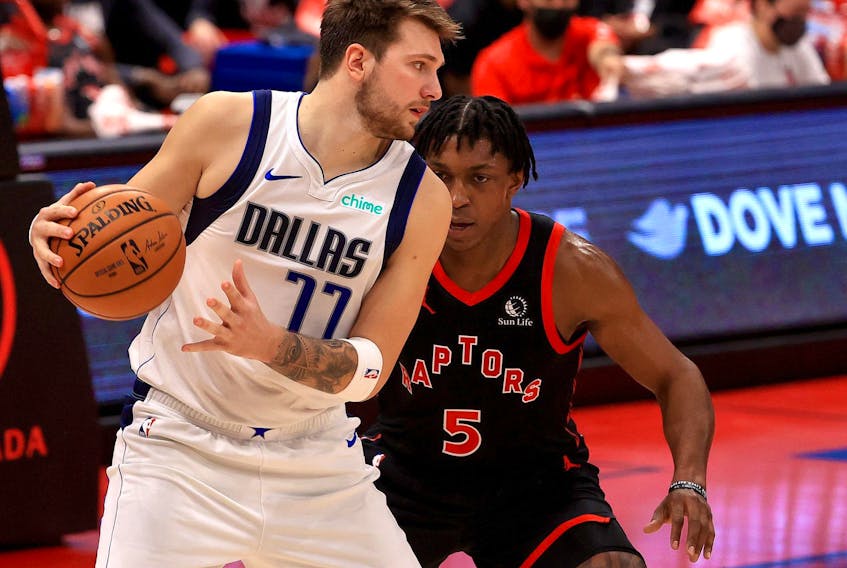 Mavericks’ Luka Doncic (right) was held in check by Stanley Johnson in the Raptors win on Monday night.