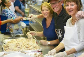 Volunteers Gayle Forrester, left, Martin Caird and Donalda Doucette help prepare a Thanksgiving dinner during the annual fundraiser at New Glasgow Lobster Suppers on Oct. 11, 2015.