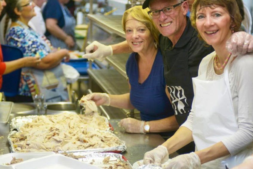 Volunteers Gayle Forrester, left, Martin Caird and Donalda Doucette help prepare a Thanksgiving dinner during the annual fundraiser at New Glasgow Lobster Suppers on Oct. 11, 2015.