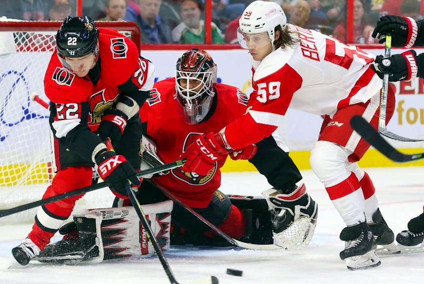 Anders Nilsson of the Ottawa Senators makes the save as Nikita Zaitsev (left) battles  Tyler Bertuzzi of the Detroit Red Wings during second period of NHL action at Canadian Tire Centre in Ottawa, October 23, 2019.   Photo by Jean Levac/Postmedia 
