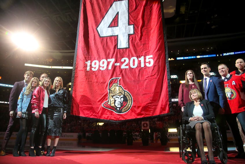  Chris Phillips and his family watch his jersey being lifted to the rafters on Tuesday night.