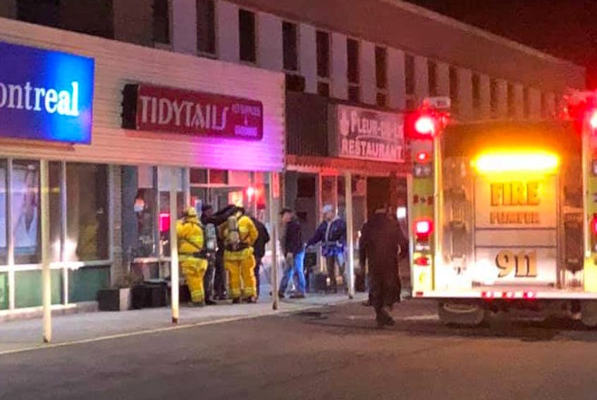 Members of the Port Hawkesbury Volunteer Fire Department are shown near Fleur-de-Lis Tea Room and Dining Room in Port Hawkesbury early Thursday morning. A fire broke out in front of the business and is believed to have been caused by a cigarette butt placed inside a flowerpot outside the location. PHOTO/FACEBOOK