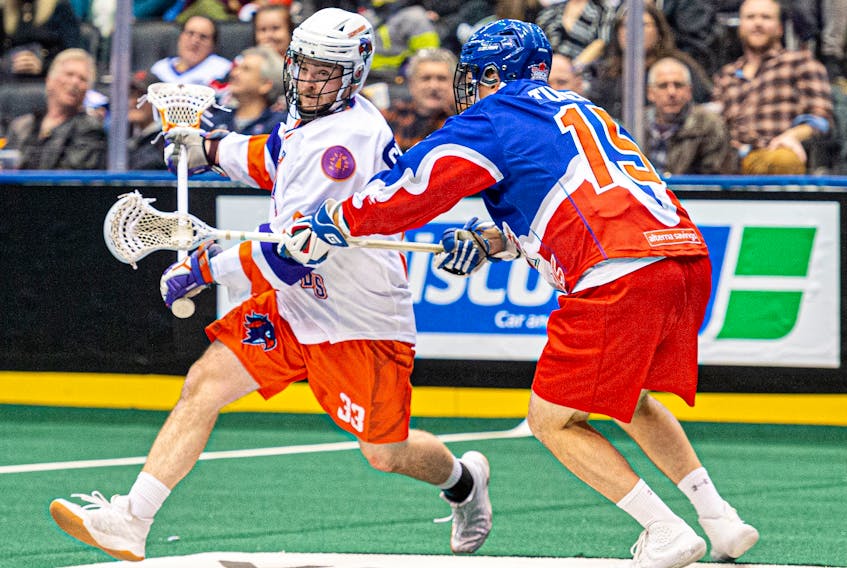 Halifax Thunderbirds’ Austin Shanks is closely defended by the Toronto Rock’s Alec Tulett during a National Lacrosse League game played Friday night in Toronto. The Rock won 12-9.