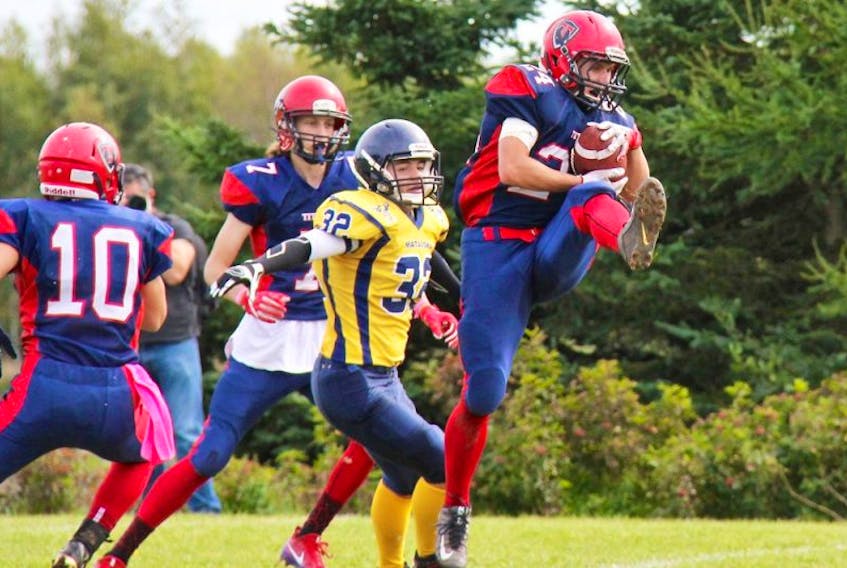 Tantramar Titan Sam Alward goes up for the interception during Saturday’s home game against the Mathieu Martin Matadors. Tantramar dominated the opposition with a final score of 93-0. PAMELA SCHNEIDER PHOTO