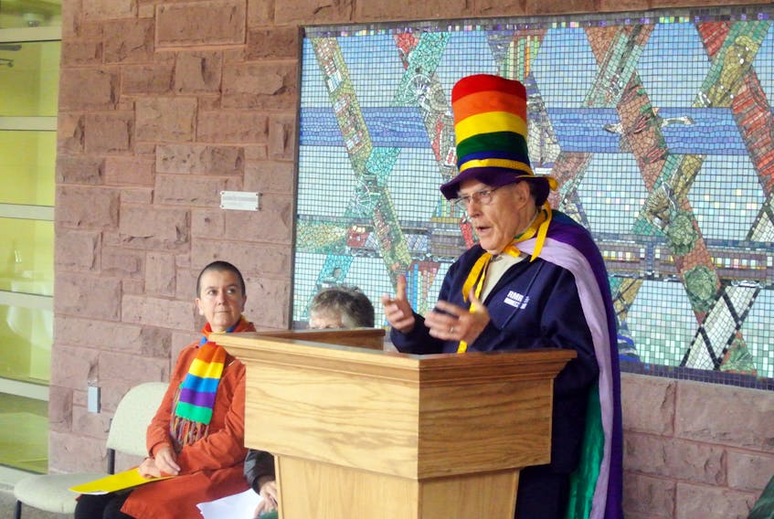 Rev. Eldon Hay, wearing his trademark rainbow hat, speaks during a 2013 Rainbow Flag raising event in Sackville.