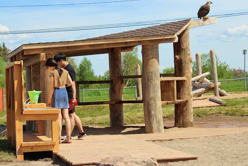 A sand kitchen and shelter are pieces included in the new natural playground.