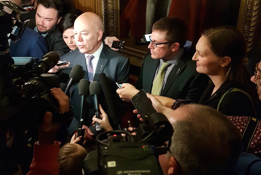 The Green Party members, from left, David Coon, Kevin Arseneau and Megan Mitton are swarmed by media following the Throne Speech last Tuesday afternoon.
