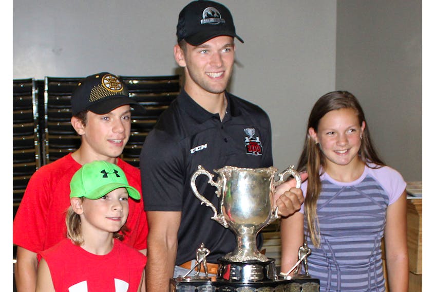 Ethan Crossman was in town last month with the Memorial Cup to meet with fans. Crossman helped lead his team, the Acadie-Bathurst Titan, to their first Canadian major junior championship win in franchise history. Above, Crossman, second from right poses with, left to right, with Ben (foreground) Jack and Jamie Arsenault.