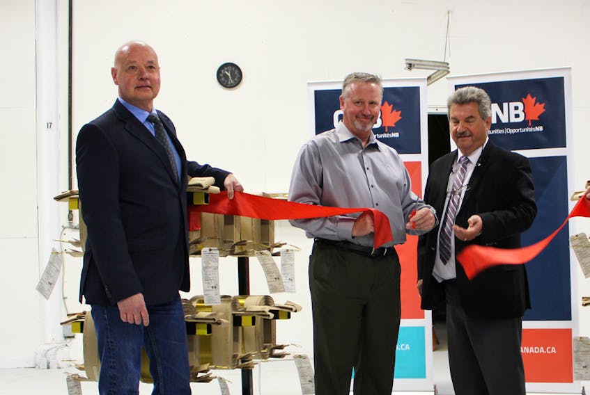 Left to right, Sackville Mayor John Higham, Kyle Campbell, Cam-Tran president and CEO, and Memramcook-Tantramar MLA Bernard LeBlanc take part in the official ribbon-cutting ceremony Friday morning.